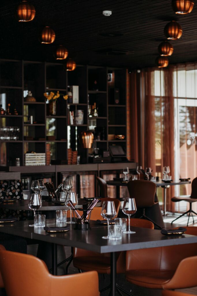 A chic and modern restaurant interior with stylish decor and mood lighting, set for dining.