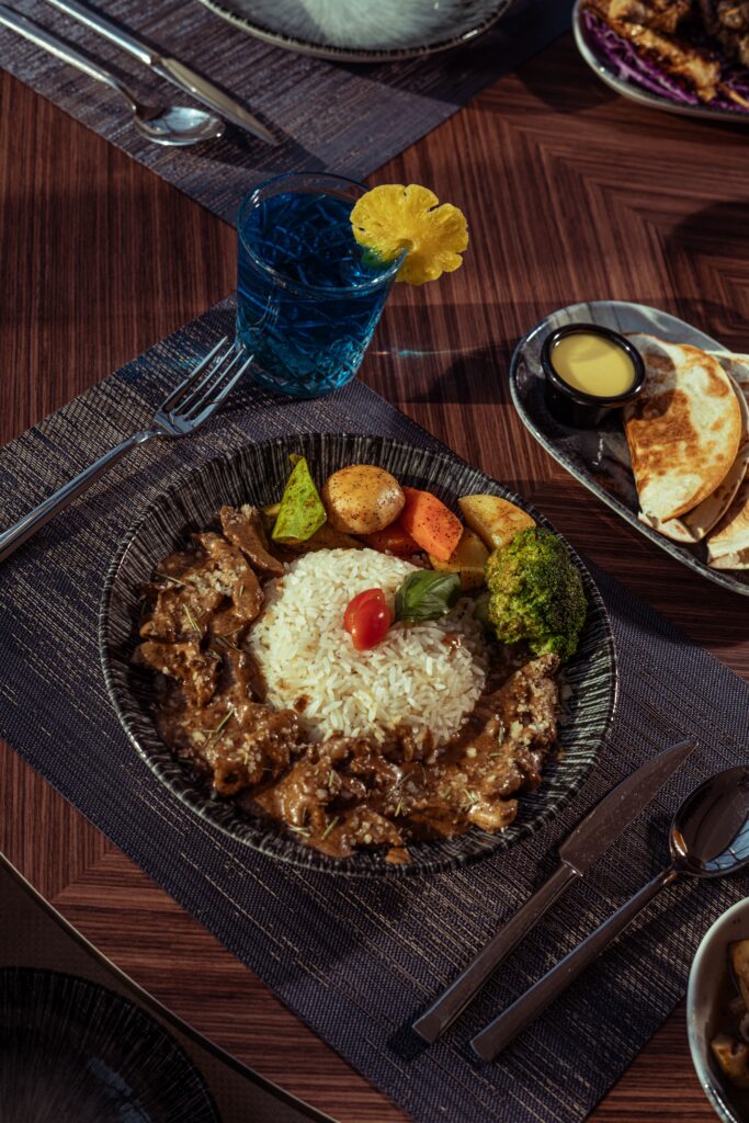 Delicious Middle Eastern dish featuring rice, vegetables, and meat served on a dining table in Baghdad.